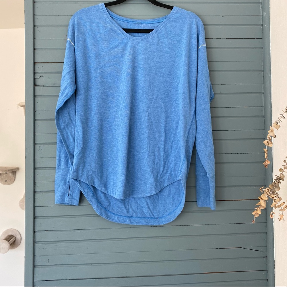 SIZE 6; Light blue long sleeve lululemon shirt with white stitching on shoulder